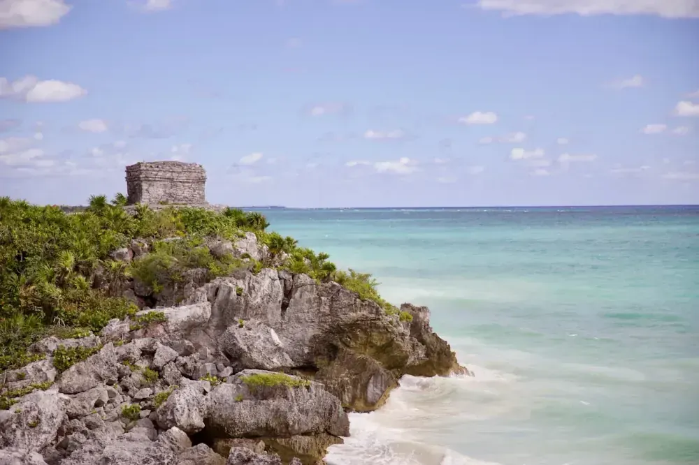 Tulum ruins El Castillo temple on cliff above turquoise Caribbean Sea, Quintana Roo Mexico