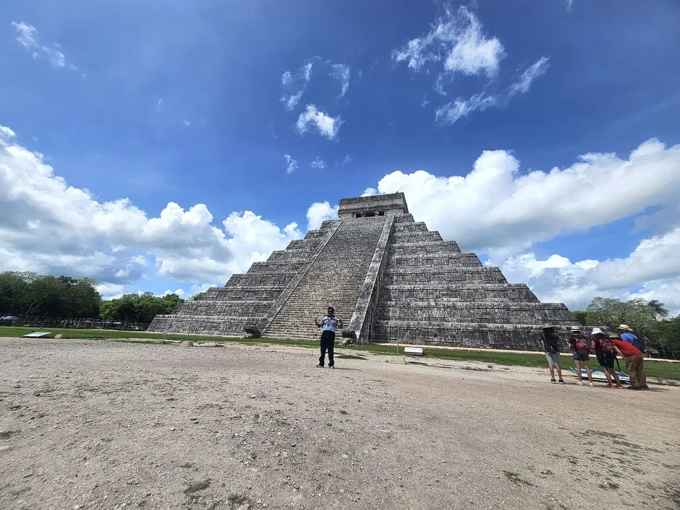 Tour guide standing in front of El Castillo pyramid at Chichen Itza