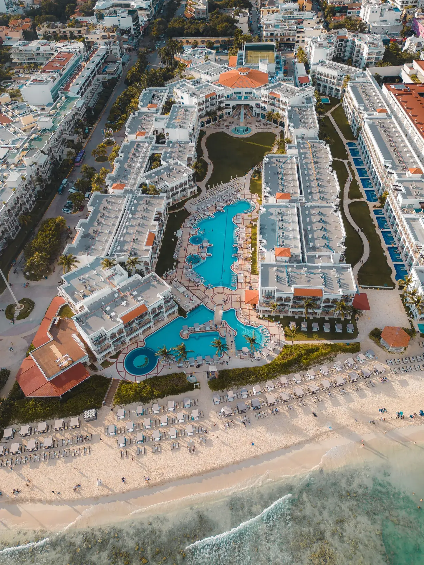 Aerial view of a luxury beachfront resort with pools in Playa del Carmen, Riviera Maya Mexico